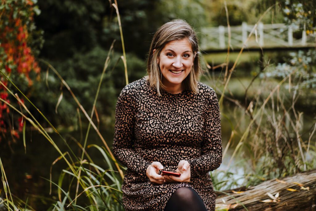 Emily from Yellow Tuxedo holding a mobile phone. digital upskilling businesses to improve their online presence. This week we talk alt tags on instagram
