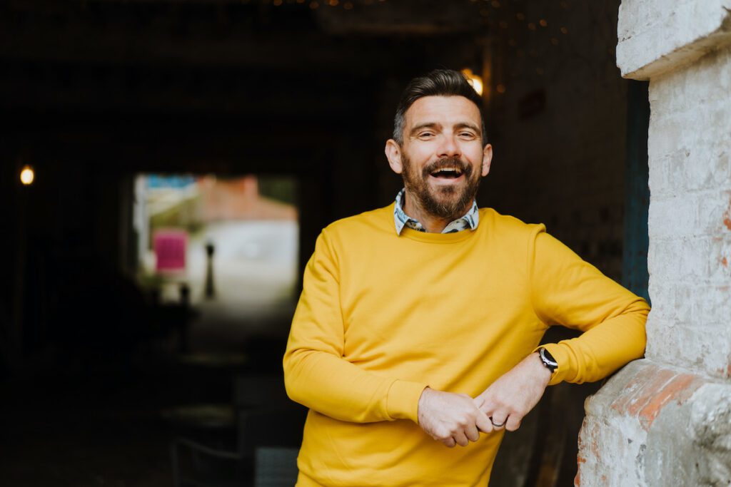 how to repurpose content for social media with Alan Braithwaite from Yellow Tuxedo wearing a yellow sweater